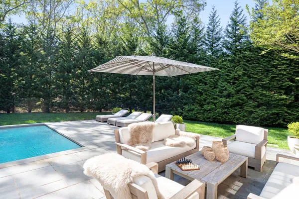 a view of backyard with outdoor seating barbeque oven and trees