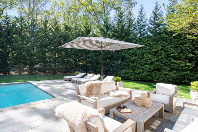 a view of backyard with outdoor seating barbeque oven and trees