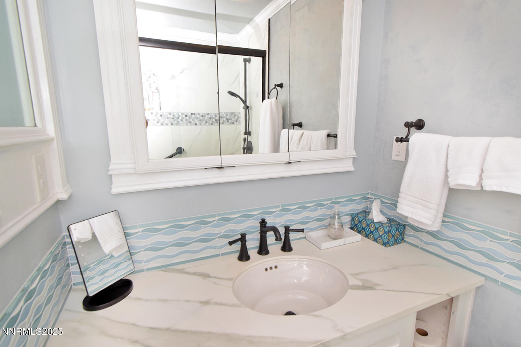 3050 Attridge Place Reno, NV 89503 - Photo 26 of 62 a bathroom with a sink and a large mirror