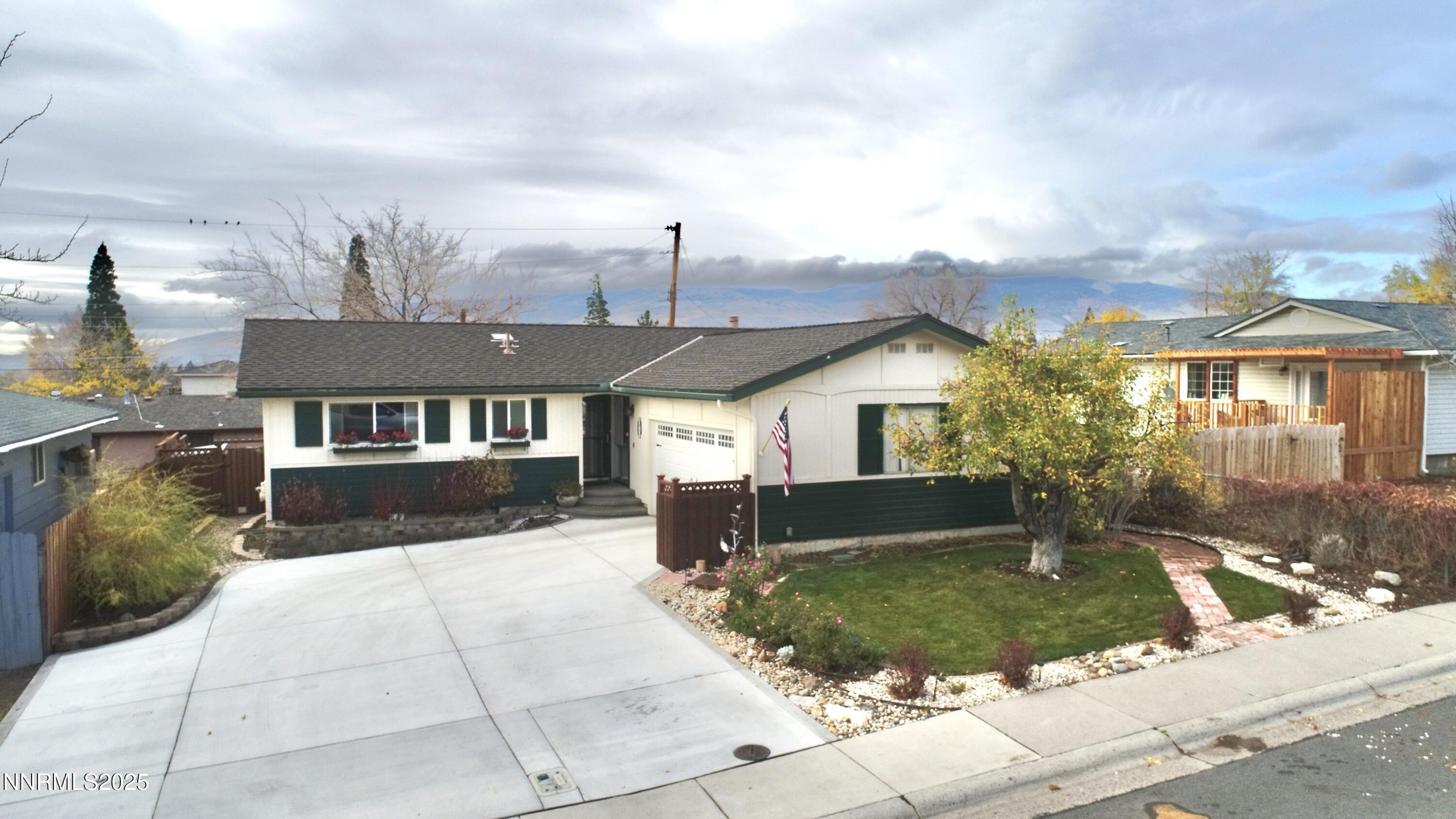 3050 Attridge Place Reno, NV 89503 - Photo 61 of 62 a front view of a house with a yard and garage