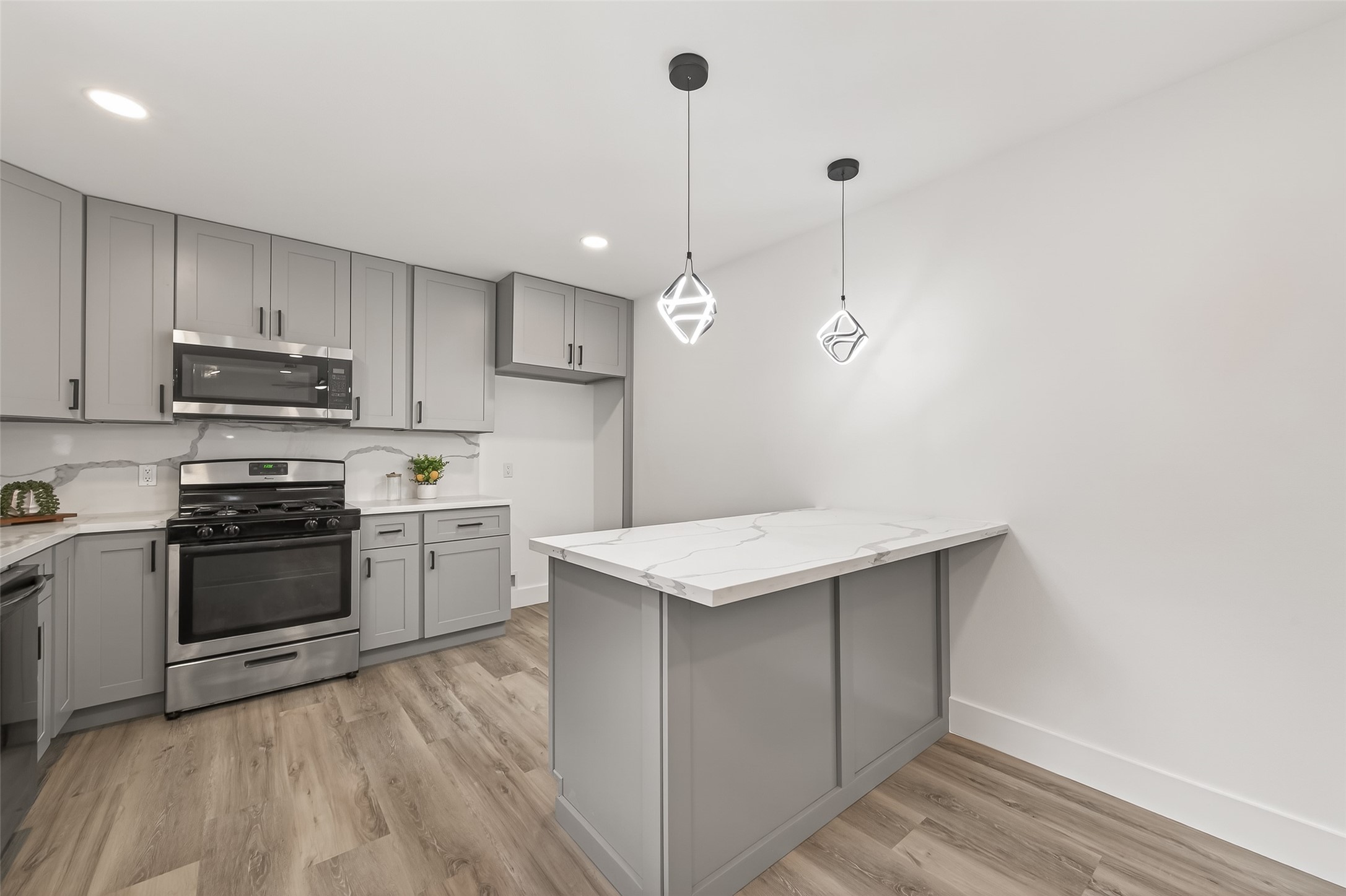 29514 Loddington Street Spring, TX 77386 - Photo 11 of 38 a kitchen with a sink a stove a microwave and cabinets