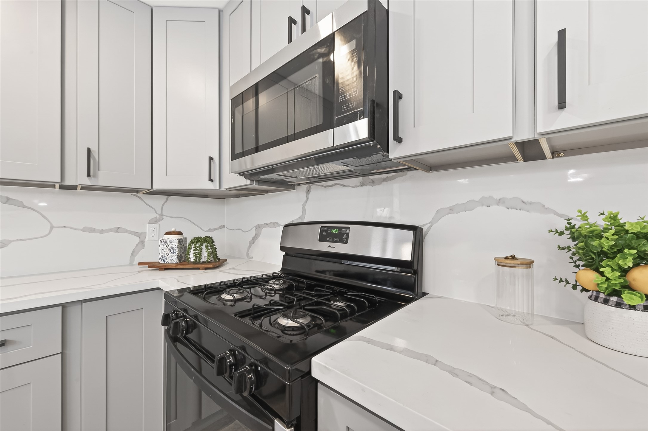 29514 Loddington Street Spring, TX 77386 - Photo 15 of 38 a kitchen with stainless steel appliances granite countertop a stove a microwave and a sink