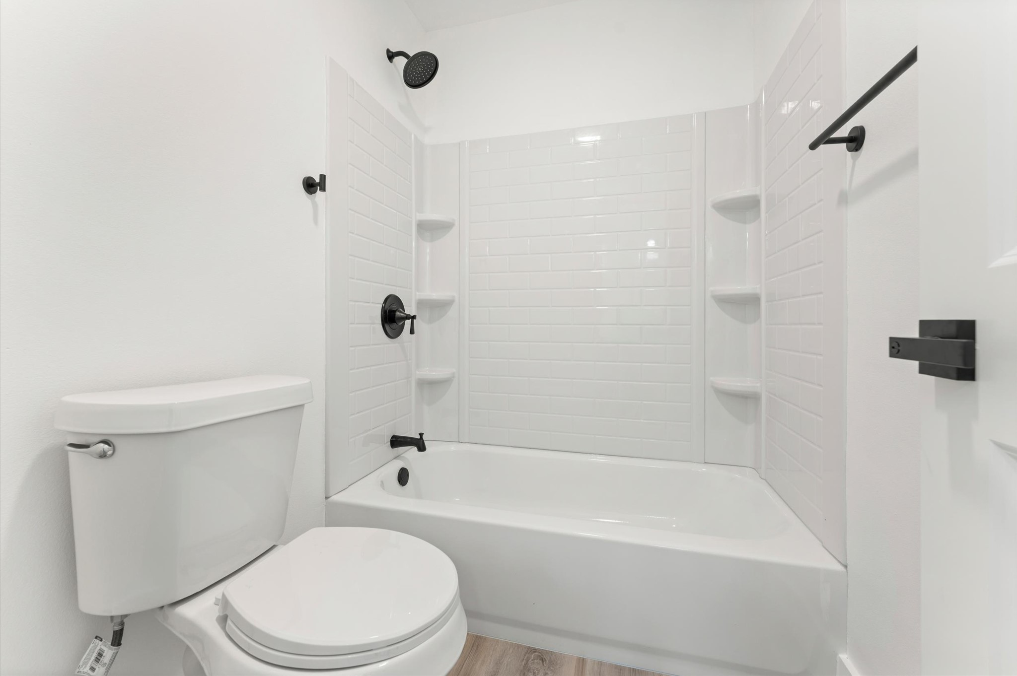29514 Loddington Street Spring, TX 77386 - Photo 27 of 38 a white toilet and tub sitting next to a bathroom sink