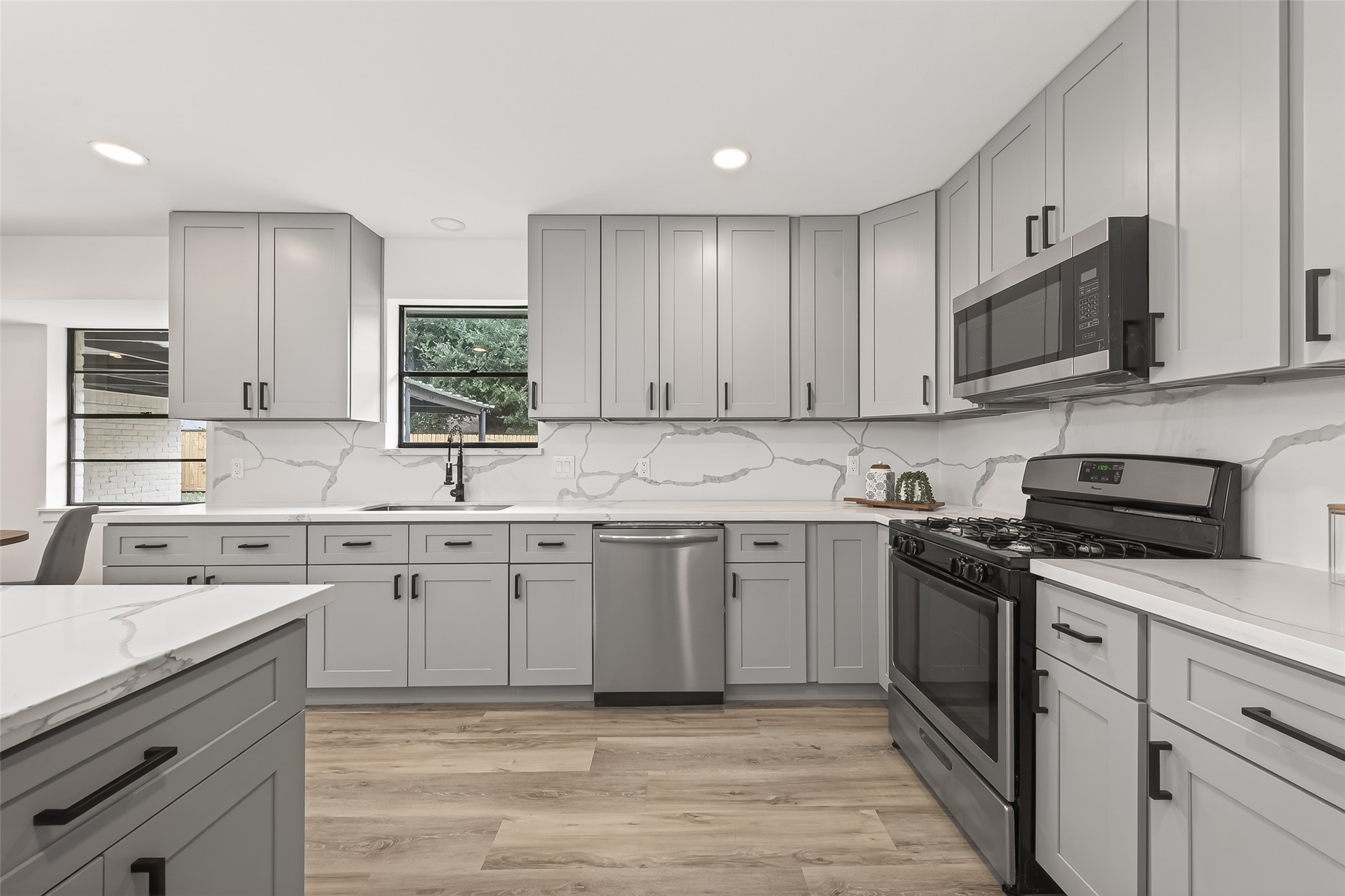 29514 Loddington Street Spring, TX 77386 - Photo 9 of 38 a kitchen with stainless steel appliances granite countertop a sink and stove top oven