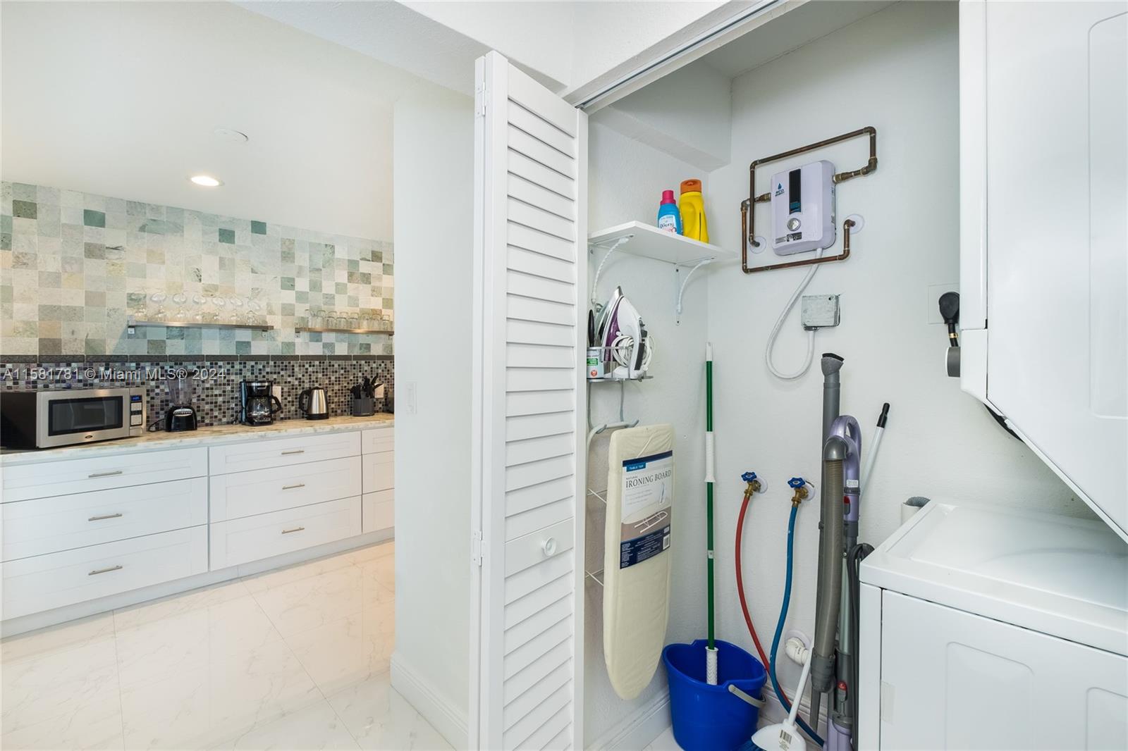 210 Southeast 4th Street Dania Beach, FL 33004 - Photo 11 of 16 a view of walk in closet with clothes and shoes