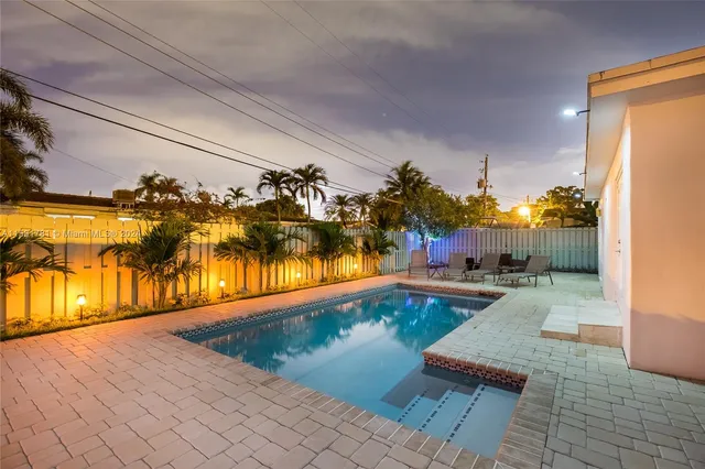 a view of a swimming pool and lounge chair