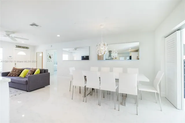 a living room with furniture a dining table and kitchen view