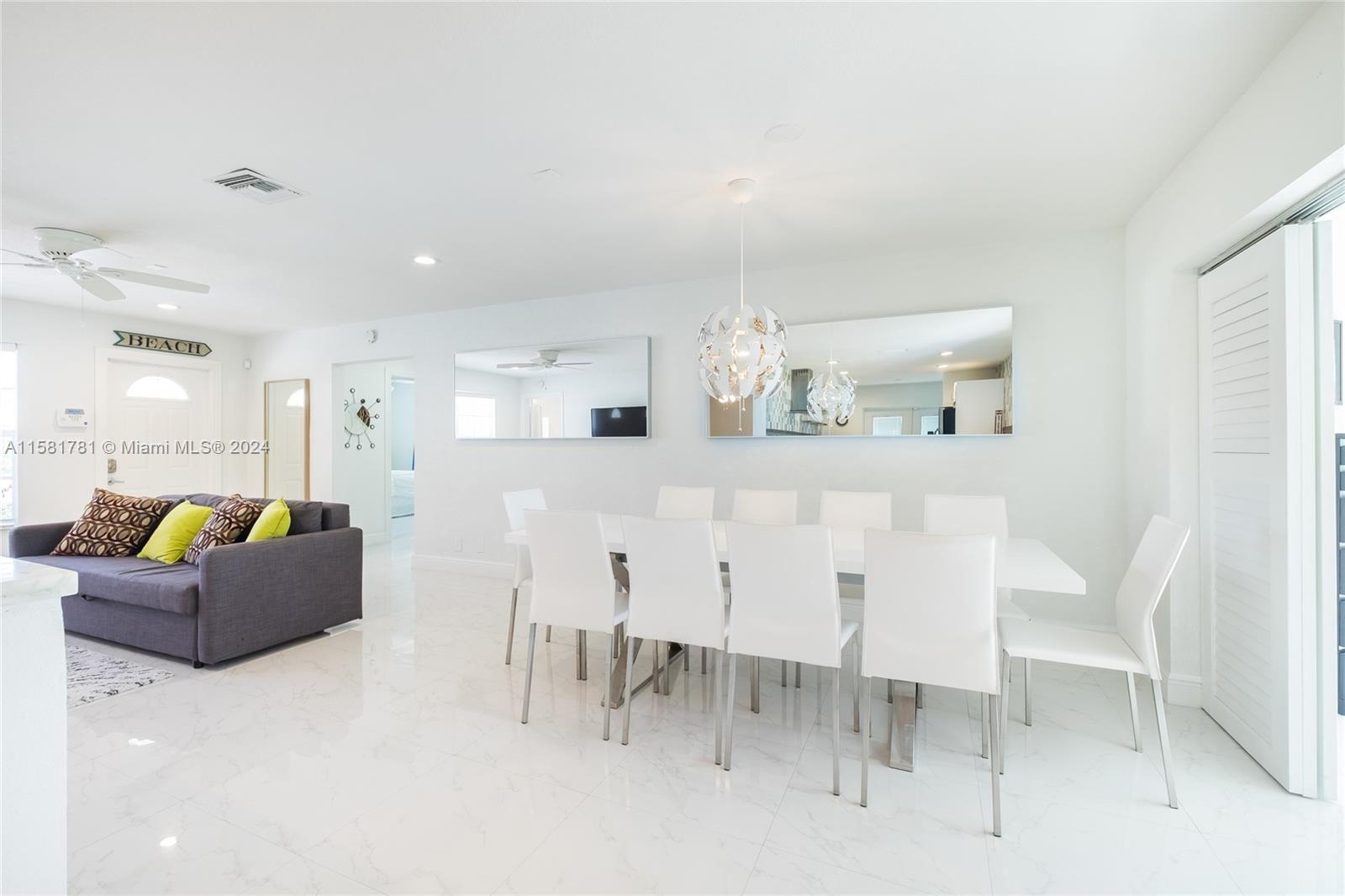 210 Southeast 4th Street Dania Beach, FL 33004 - Photo 4 of 16 a living room with furniture a dining table and kitchen view