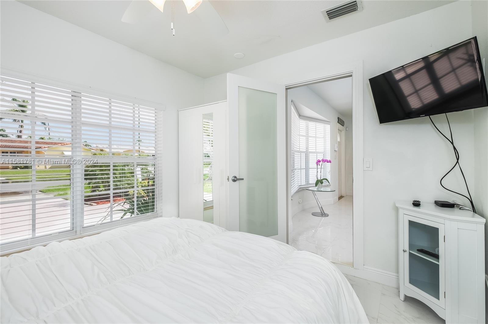 210 Southeast 4th Street Dania Beach, FL 33004 - Photo 7 of 16 a bedroom with a bed and a television