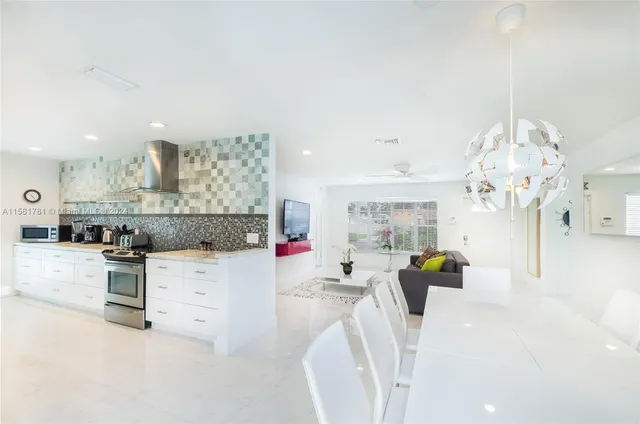 a living room with kitchen island furniture and a chandelier