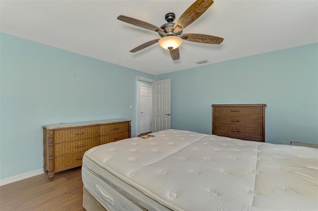 2490 Eleventh Street Englewood, FL 34224 - Photo 20 of 49 a bedroom with a bed and a chandelier