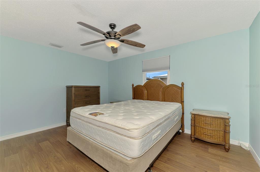 2490 Eleventh Street Englewood, FL 34224 - Photo 21 of 49 a bedroom with a bed and a chandelier