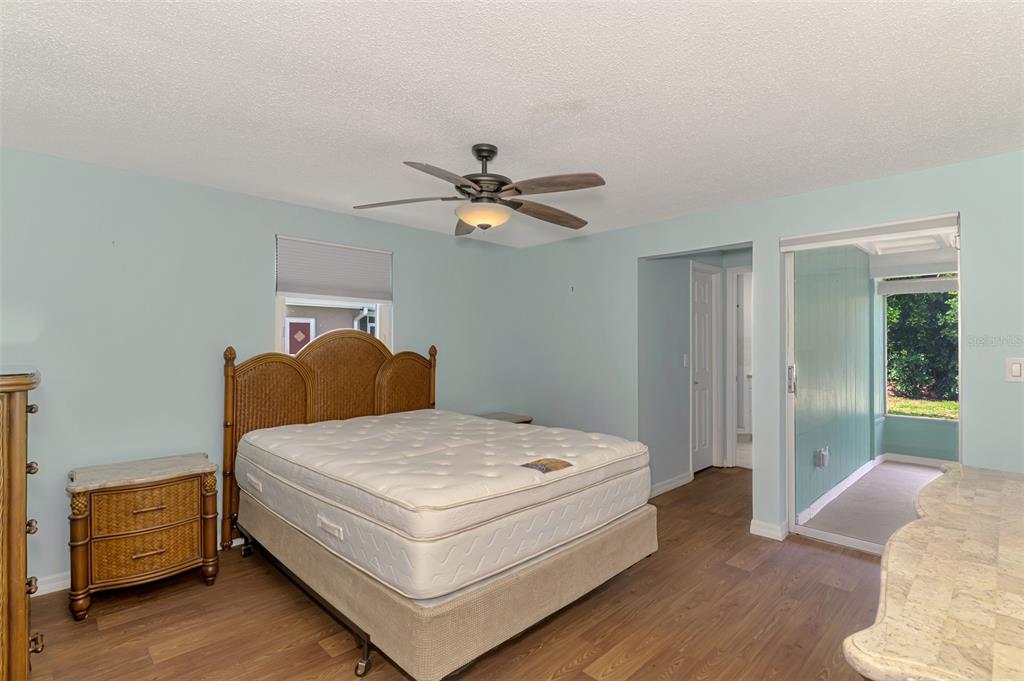 2490 Eleventh Street Englewood, FL 34224 - Photo 23 of 49 a bedroom with a bed and a chandelier