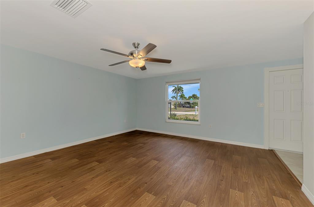 2490 Eleventh Street Englewood, FL 34224 - Photo 27 of 49 an empty room with wooden floor and window