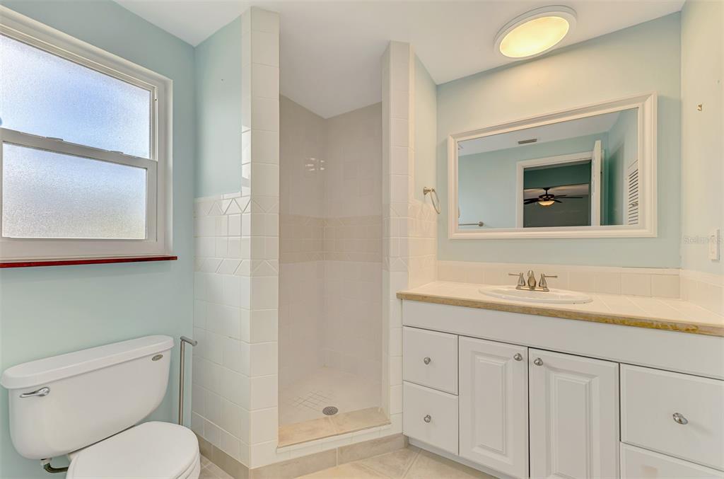 2490 Eleventh Street Englewood, FL 34224 - Photo 29 of 49 a bathroom with a toilet a sink and mirror