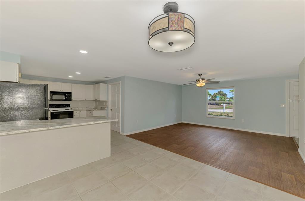 2490 Eleventh Street Englewood, FL 34224 - Photo 6 of 49 wooden floor in kitchen and a chandelier