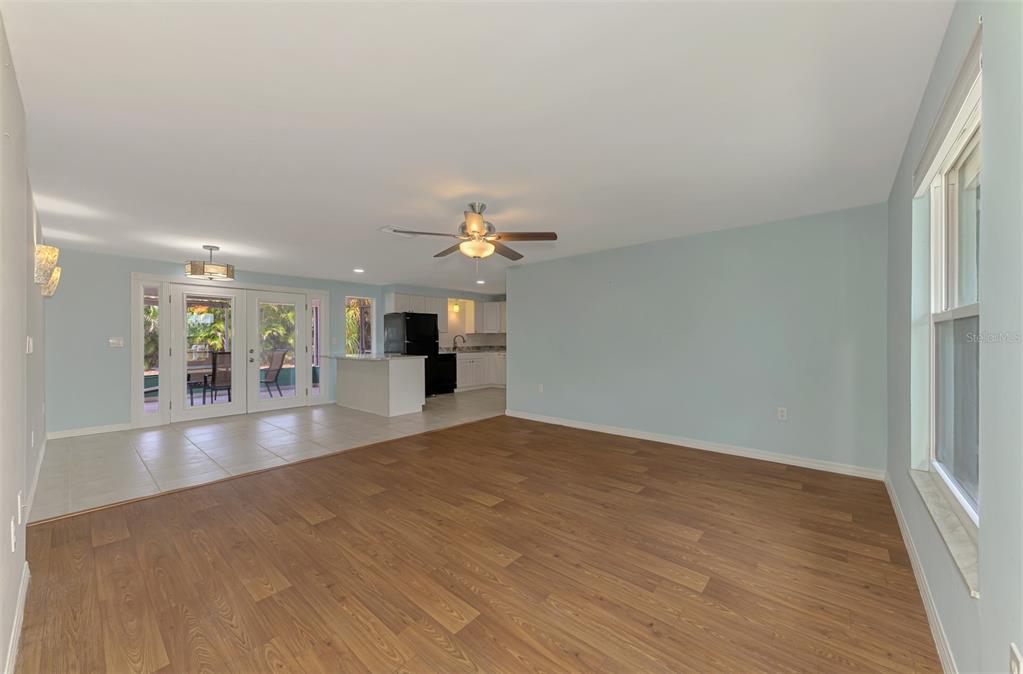 2490 Eleventh Street Englewood, FL 34224 - Photo 7 of 49 wooden floor in an empty room with a window