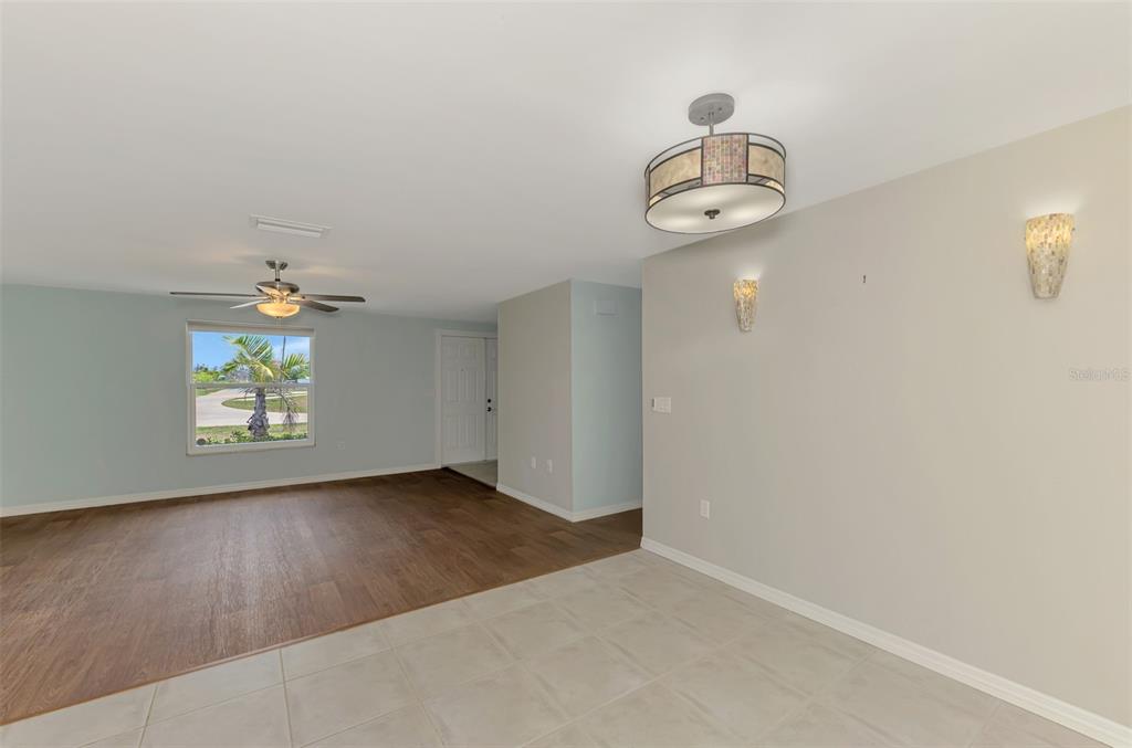2490 Eleventh Street Englewood, FL 34224 - Photo 8 of 49 an empty room with wooden floor ceiling fan and windows