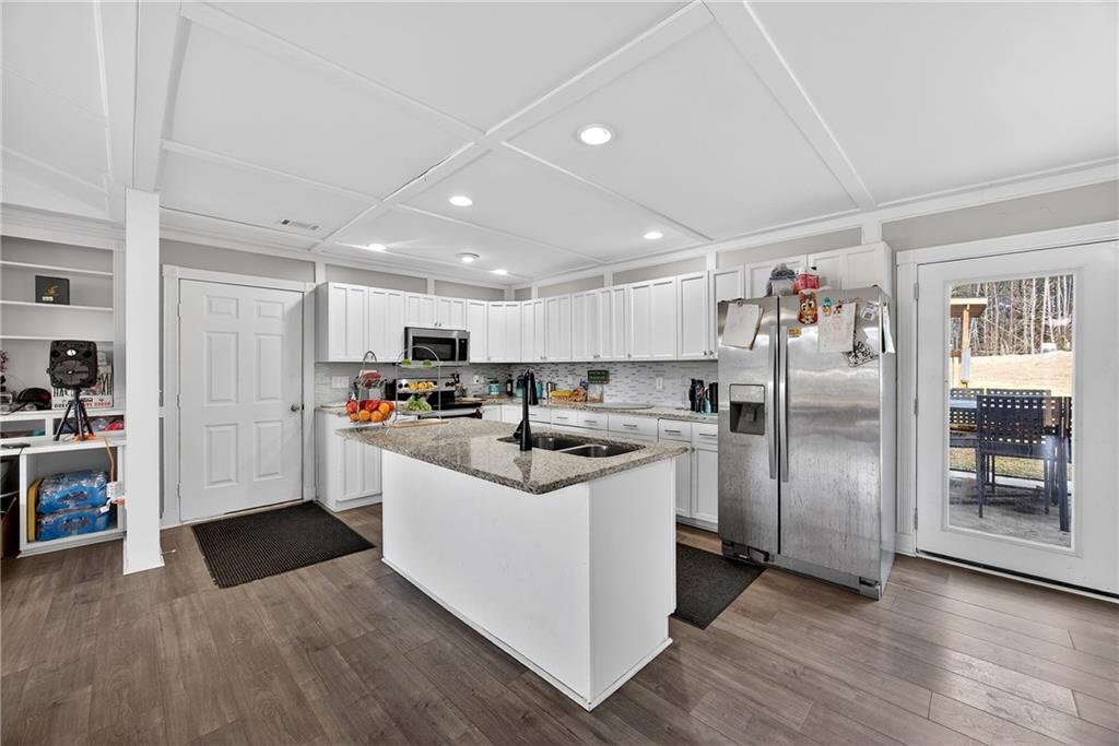 505 Stone Road McDonough, GA 30253 - Photo 13 of 28 a kitchen with stainless steel appliances kitchen island granite countertop a refrigerator and a sink