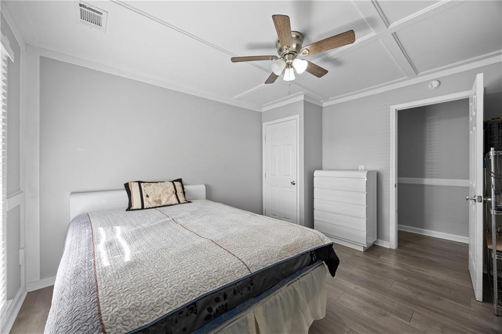 505 Stone Road McDonough, GA 30253 - Photo 18 of 28 a bedroom with a bed and a chandelier