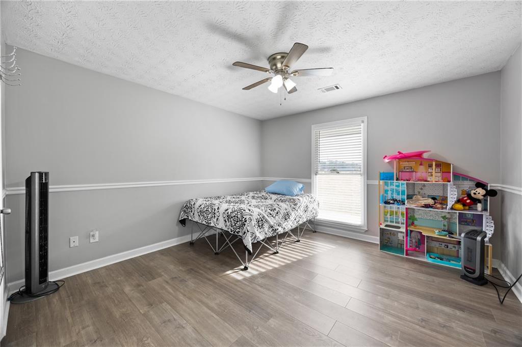 505 Stone Road McDonough, GA 30253 - Photo 20 of 28 a bedroom with furniture and a window