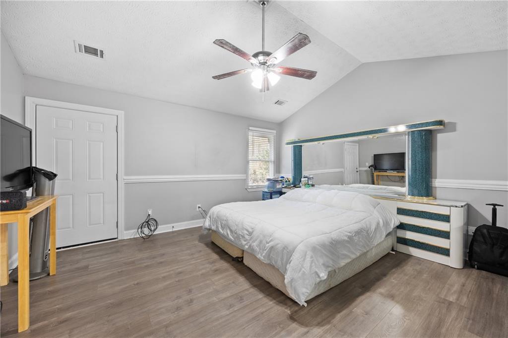 505 Stone Road McDonough, GA 30253 - Photo 22 of 28 a bedroom with a bed and a chandelier