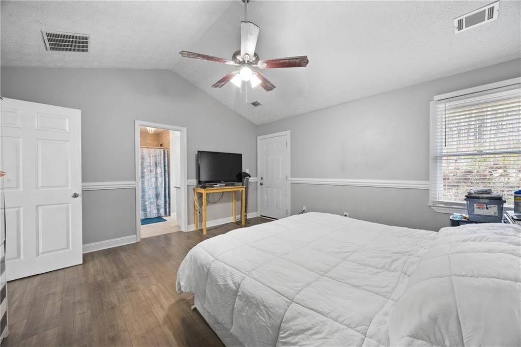 505 Stone Road McDonough, GA 30253 - Photo 23 of 28 a bedroom with a bed and a flat screen tv