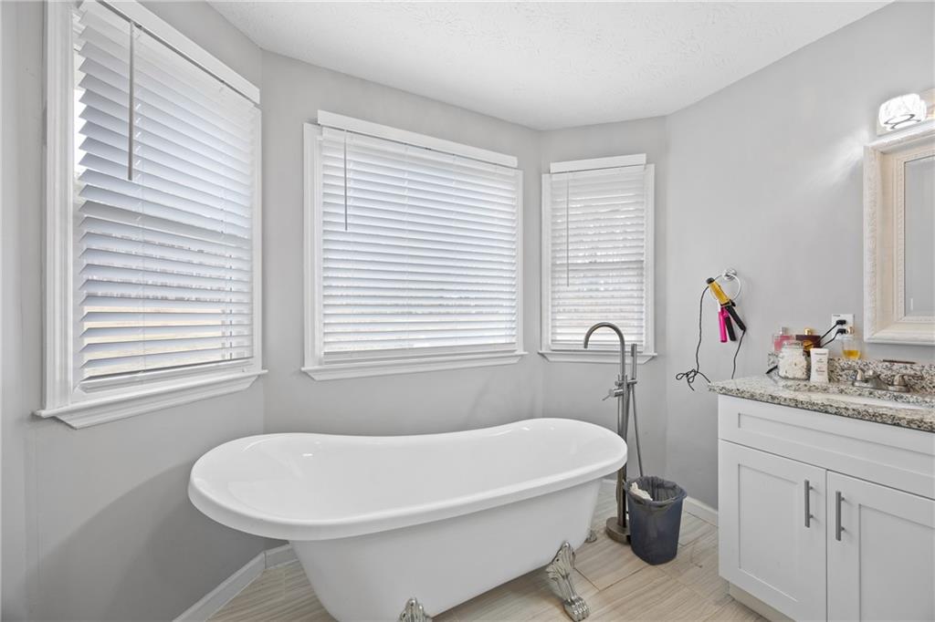 505 Stone Road McDonough, GA 30253 - Photo 24 of 28 a white bath tub sitting next to a white sink