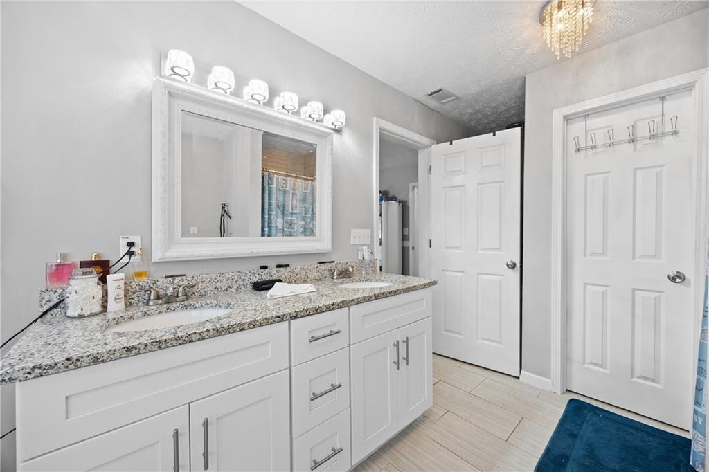 505 Stone Road McDonough, GA 30253 - Photo 25 of 28 a bathroom with double sink and a mirror