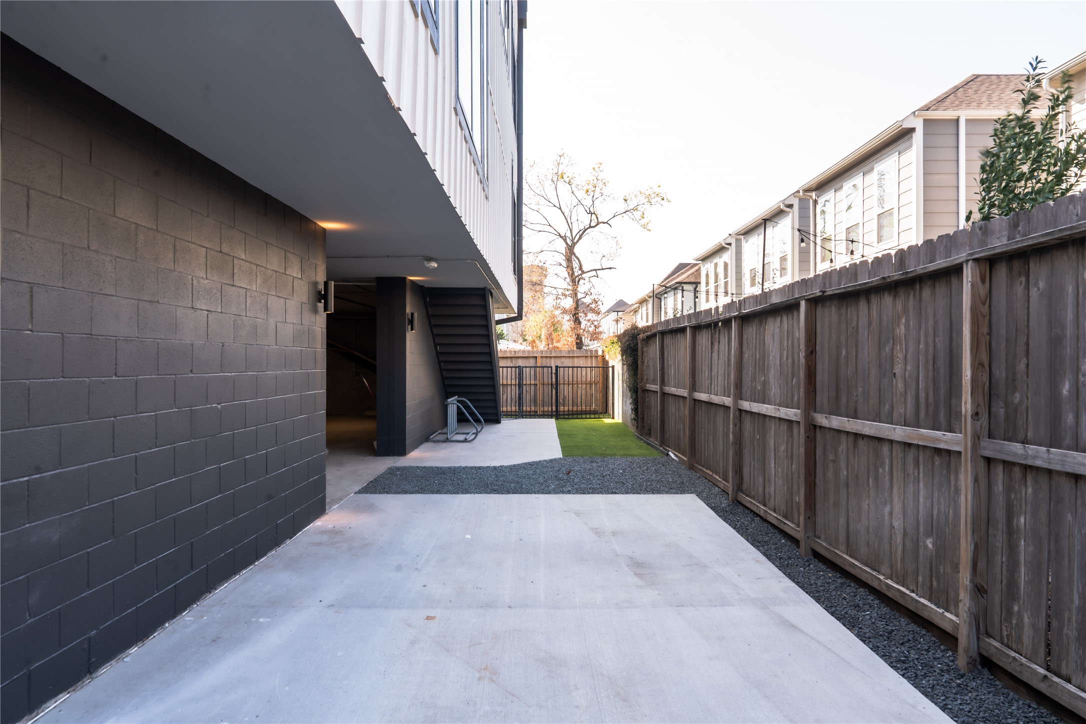 5614 Larkin Street, Unit E Houston, TX 77007 - Photo 15 of 19 a view of a pathway of a building with wooden fence