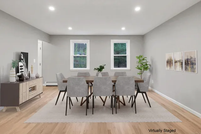 a view of a dining room with furniture and wooden floor