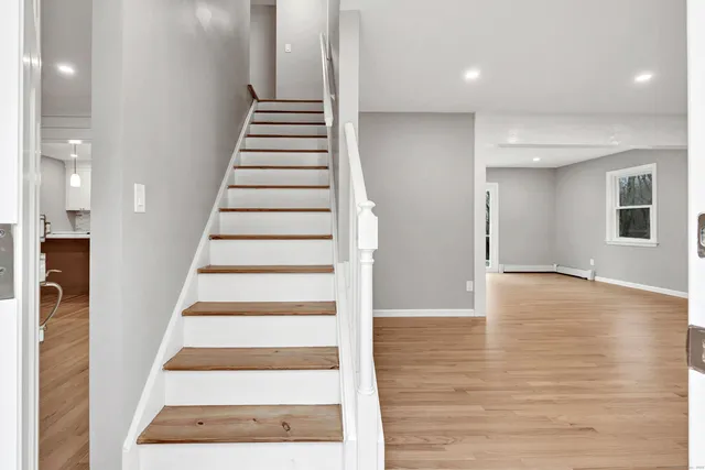 a view of an entryway with wooden floor and door