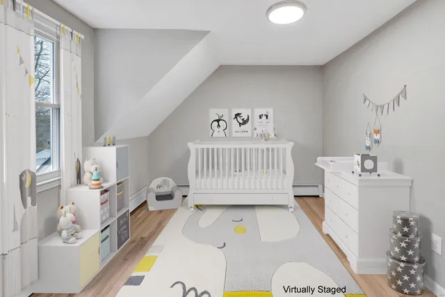 a living room with furniture and a baby crib