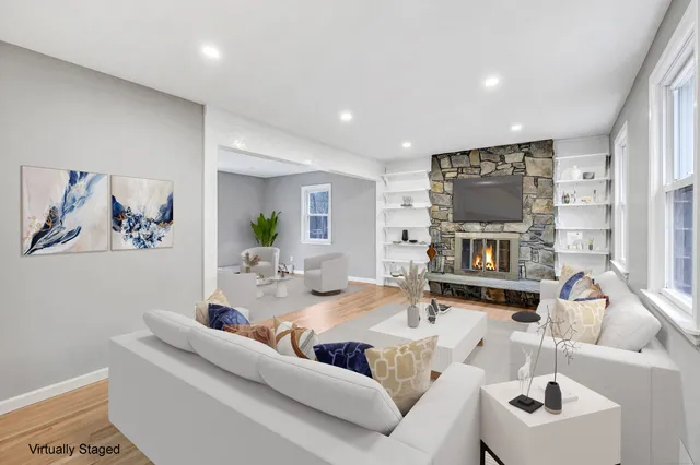 a living room with furniture a fireplace and a flat screen tv