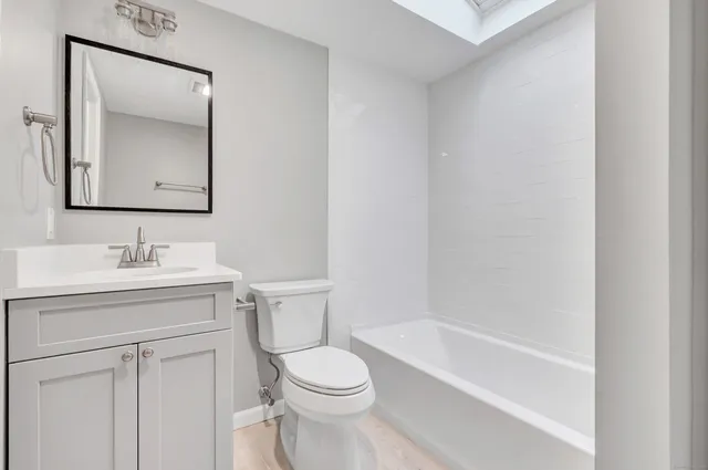 a bathroom with a sink toilet and vanity