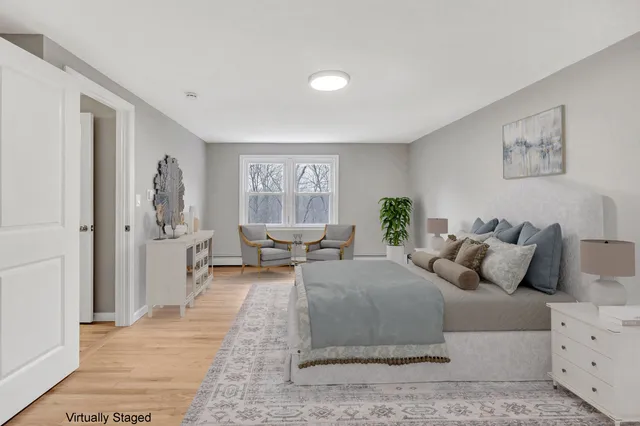 a bedroom with a large bed and a window