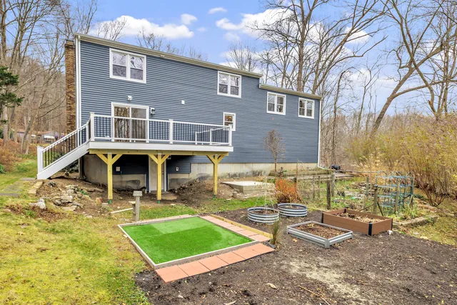 a view of a house with backyard porch and sitting area