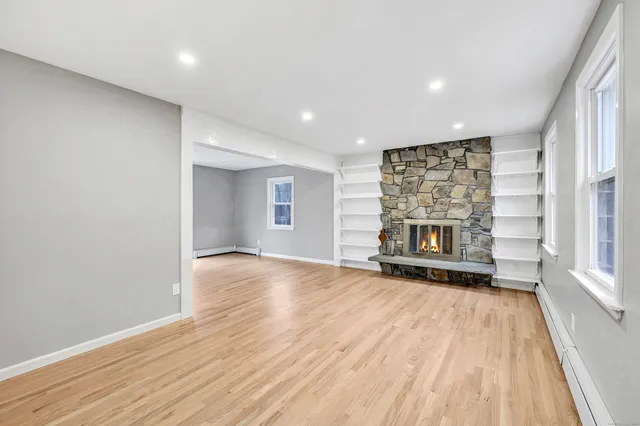 wooden floor in an empty room with a fireplace
