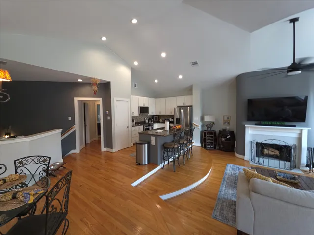 a living room with furniture flat screen tv and a fireplace