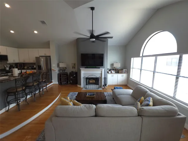 a living room with furniture a fireplace and a flat screen tv