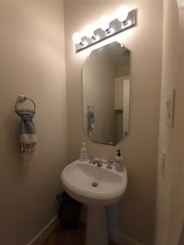 a bathroom with a sink a mirror and vanity