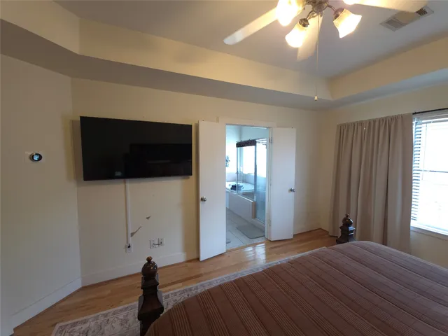 a bedroom with a bed and a flat screen tv