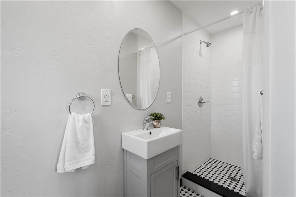 916 McGovern Road Houston, PA 15342 - Photo 27 of 44 A full shower was added where a closet used to be located to give showcase the added convenience of having a full bathroom just steps off the owners suite. Custom tile work, new flooring, vanity and fixtures make this room a favorite!