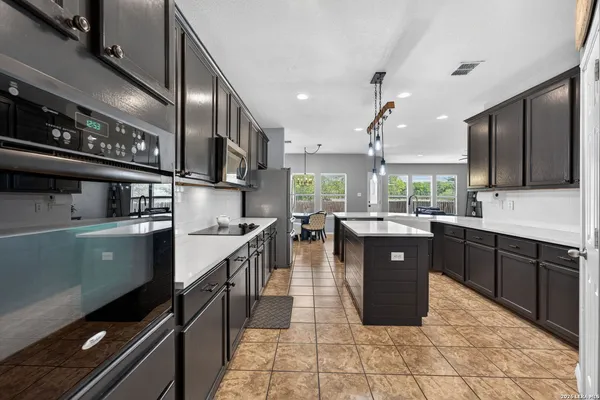 a kitchen with a sink counter top space cabinets and stainless steel appliances