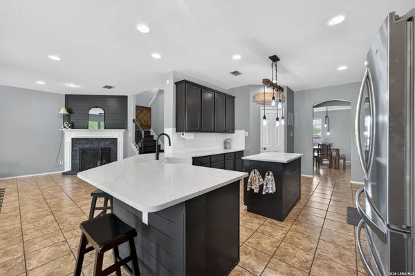 a large kitchen with a table and chairs