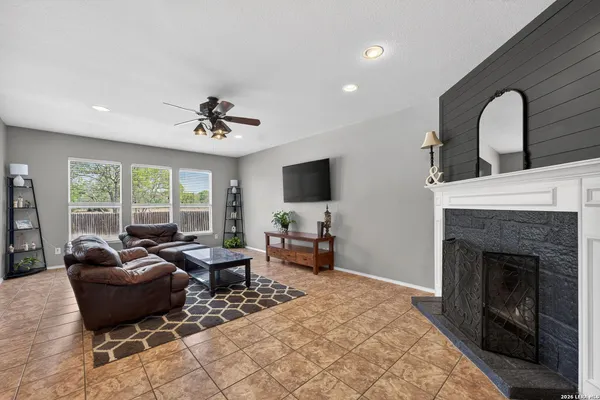 a living room with furniture fireplace and flat screen tv