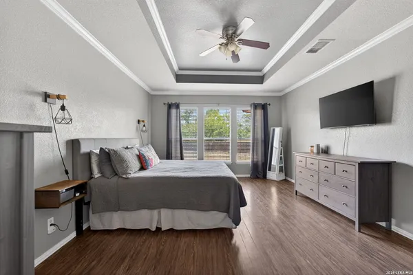 a bedroom with furniture and a flat screen tv