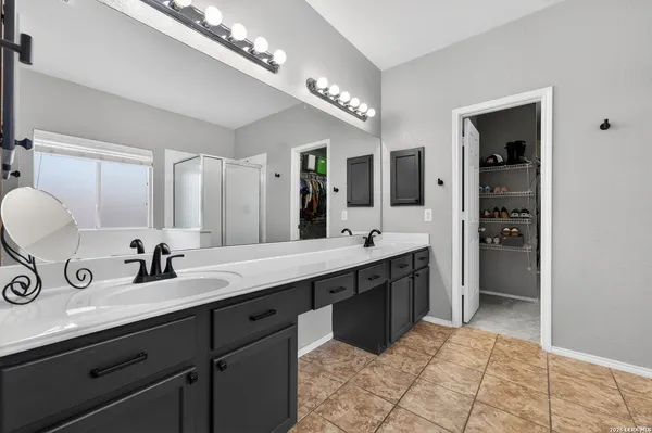 a bathroom with a sink double vanity and a mirror