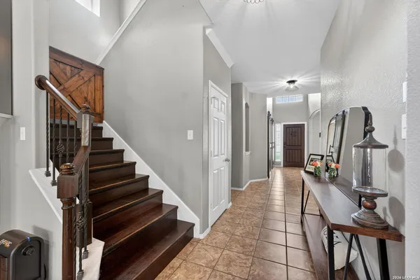 a view of a hallway with wooden floor and stairs