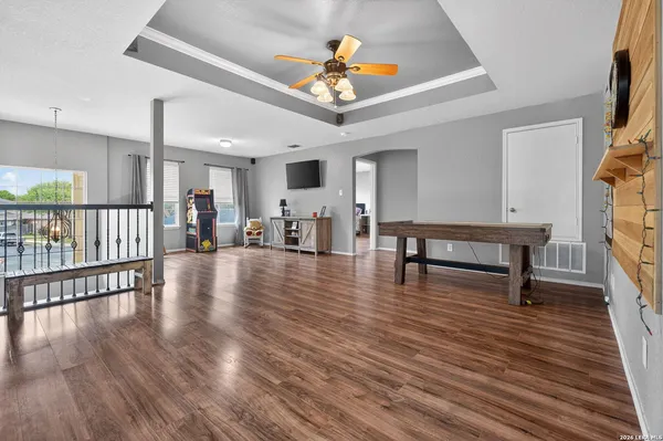 a living room with furniture and a wooden floor